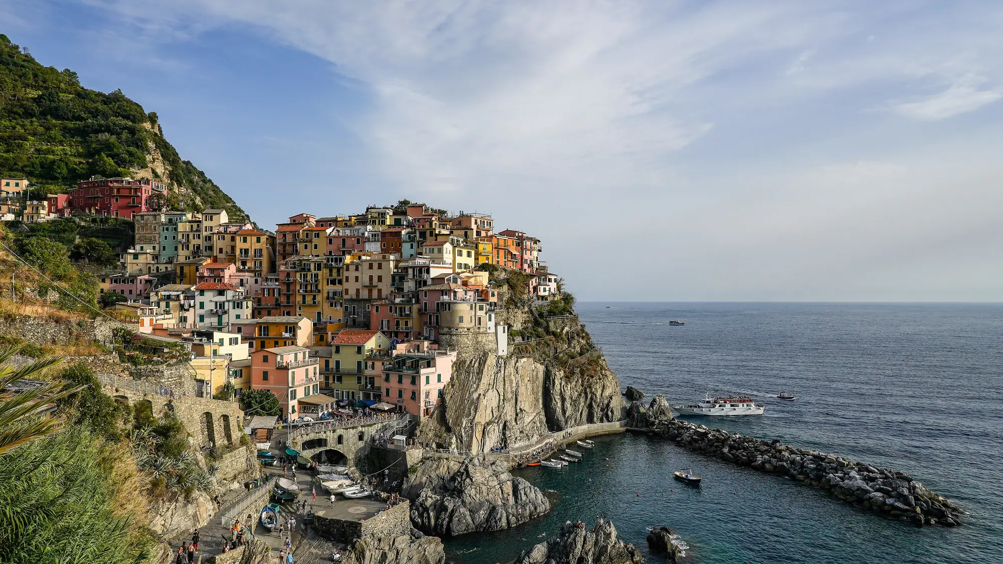 Manarola, Cinque Terre, Italy: colorful houses on the cliffs above the sea at dusk